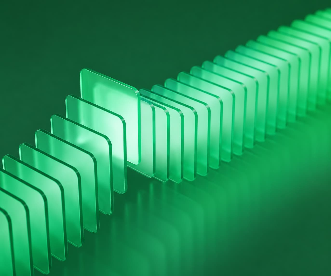 A row of translucent green glass panels toppling like dominoes