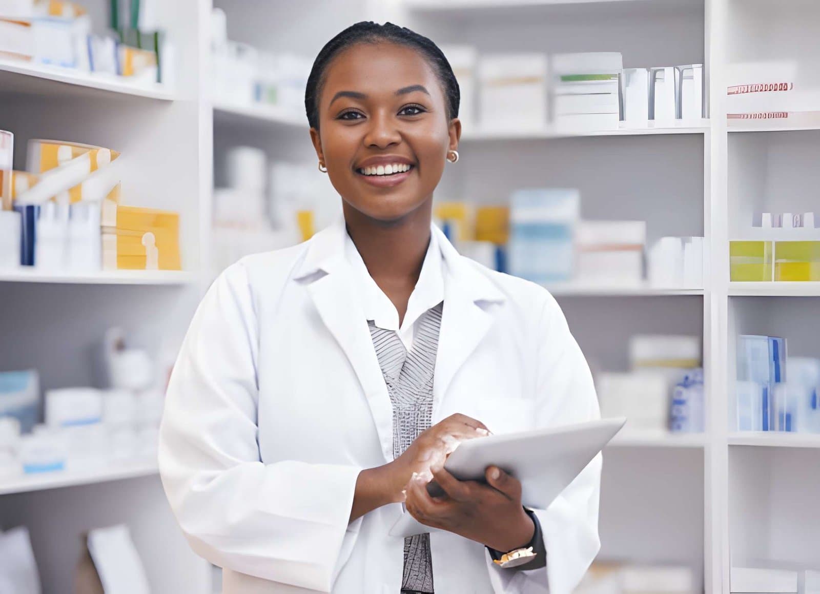 A pharmacist holding a tablet